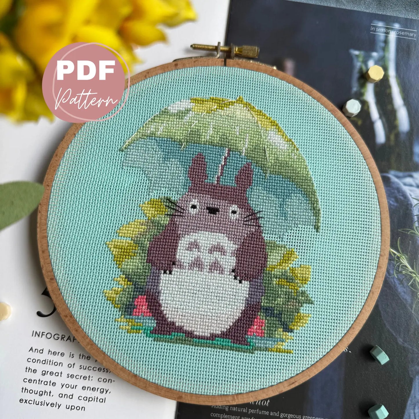 Embroidery hoop with cartoon character totoro holding an umbrella on a light blue background, with 'PDF Pattern' label.